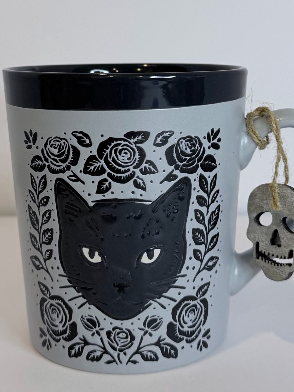 Gray Ceramic Cat Mug with Black Accents and Skull Charm